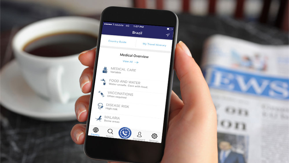 Assistance app in hand with coffee and newspaper background